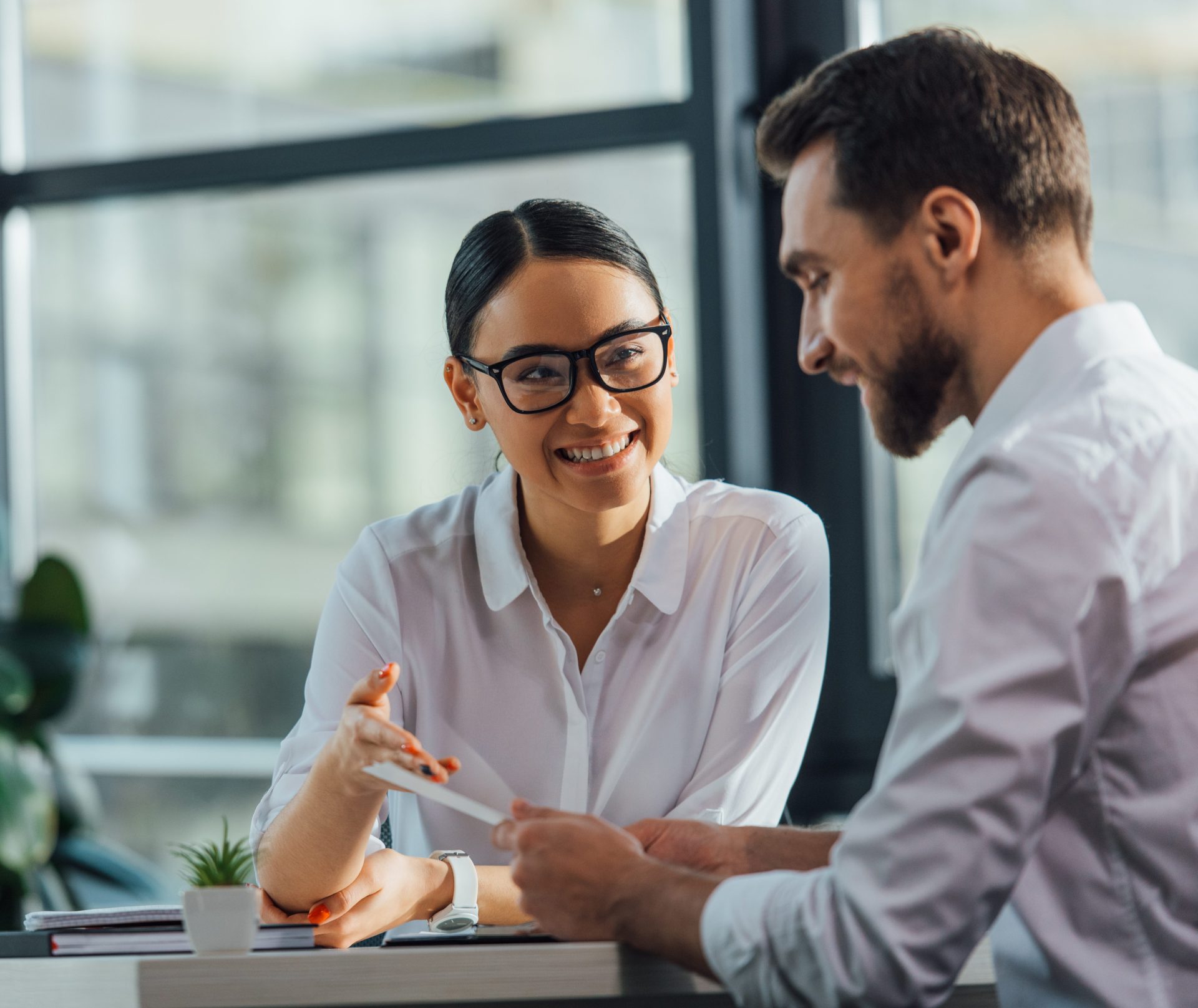 female asian translator working working with smiling businesswoman